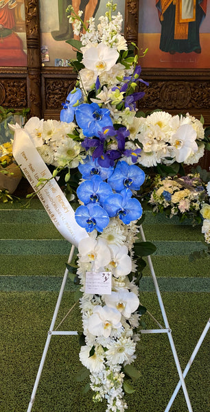 white mixed seasonal cross with shades on blue in the spray